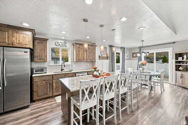 615 West 1870th Street South Payson, UT 84651 - Photo 3 of 31 Kitchen featuring wood-finish cabinetry, stainless steel refrigerator, white subway tile backsplash, and recessed lighting