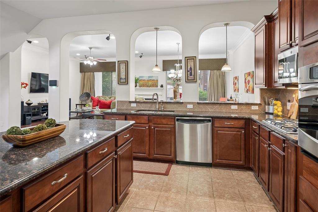 835 Rockingham Drive Irving, TX 75063 - Photo 12 of 30 Stainless appliances and a center island are in the well-appointed kitchen.