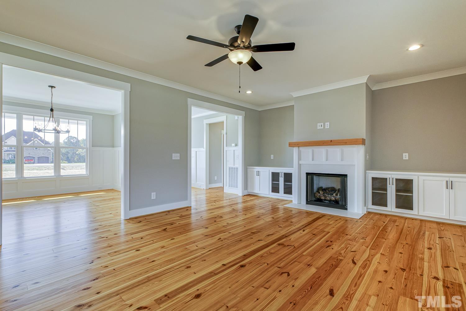 742 River Road Fuquay-Varina, NC 27526 - Photo 13 of 68 a view of empty room with wooden floor and fireplace