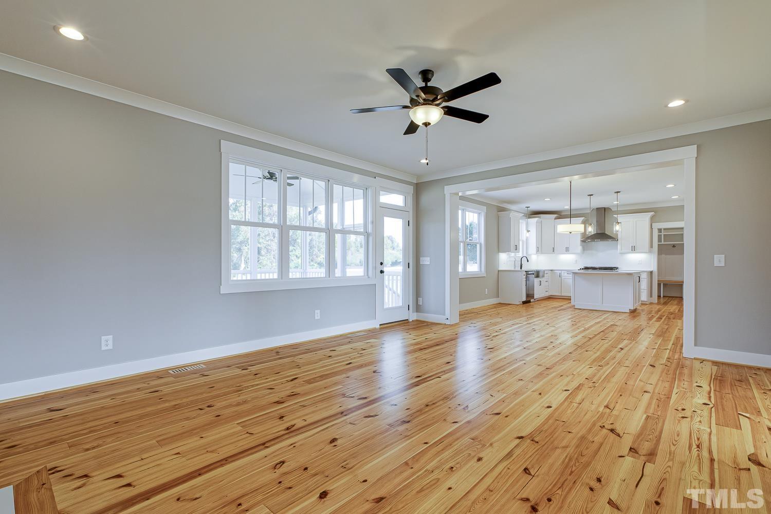 742 River Road Fuquay-Varina, NC 27526 - Photo 15 of 68 a view of an empty room with wooden floor and a window