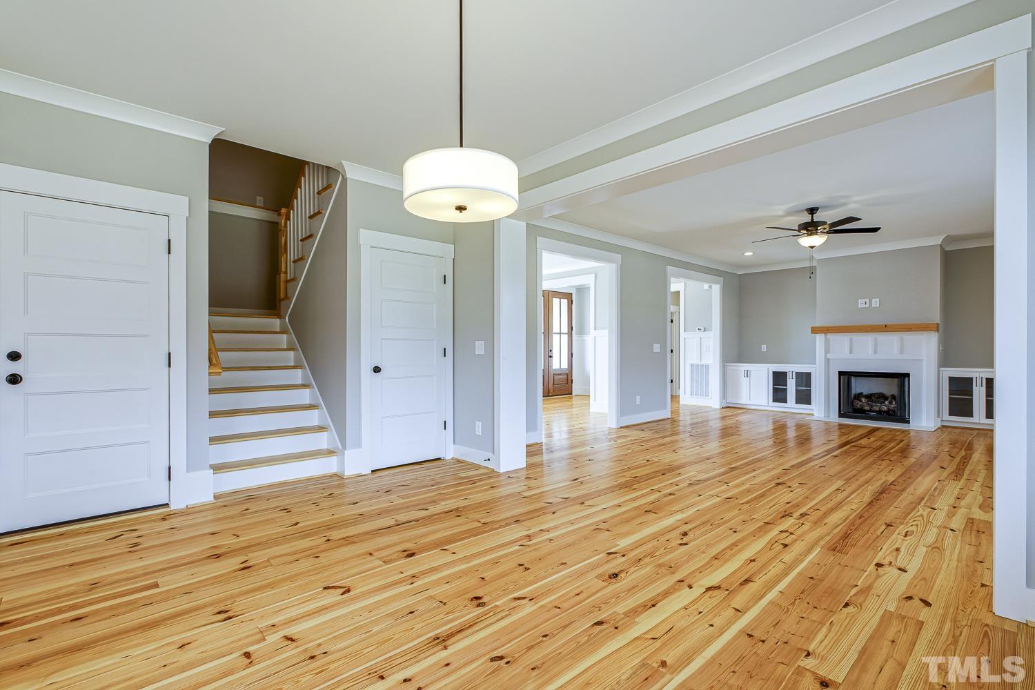 742 River Road Fuquay-Varina, NC 27526 - Photo 18 of 68 a view of a livingroom with wooden floor and fireplace
