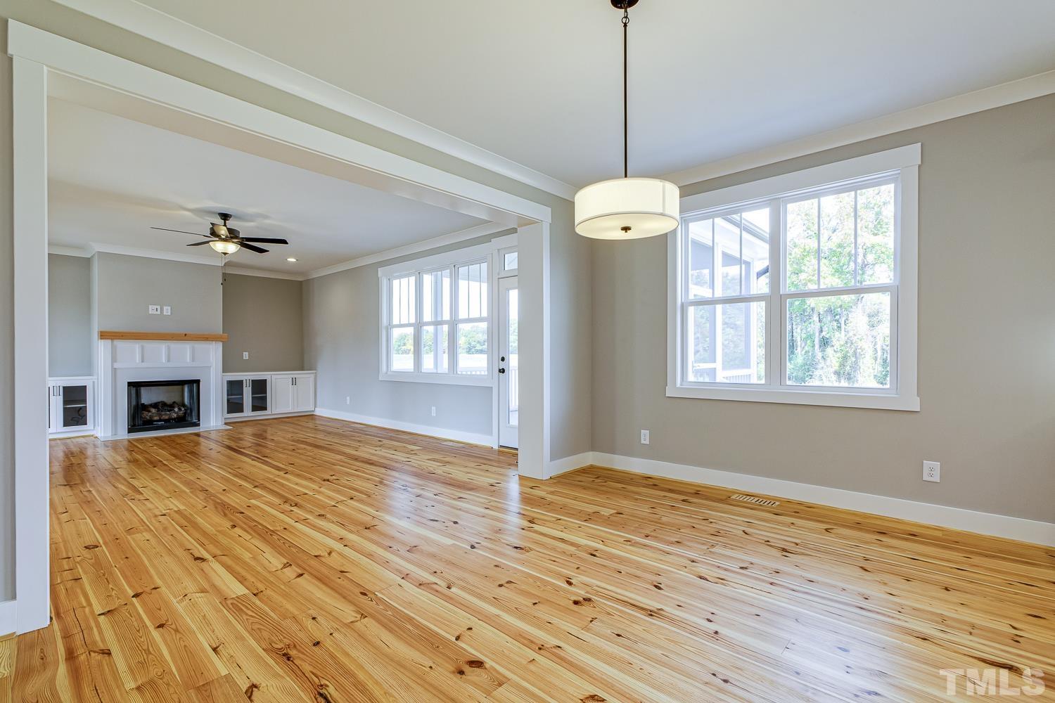 742 River Road Fuquay-Varina, NC 27526 - Photo 19 of 68 a view of an empty room with wooden floor and a window
