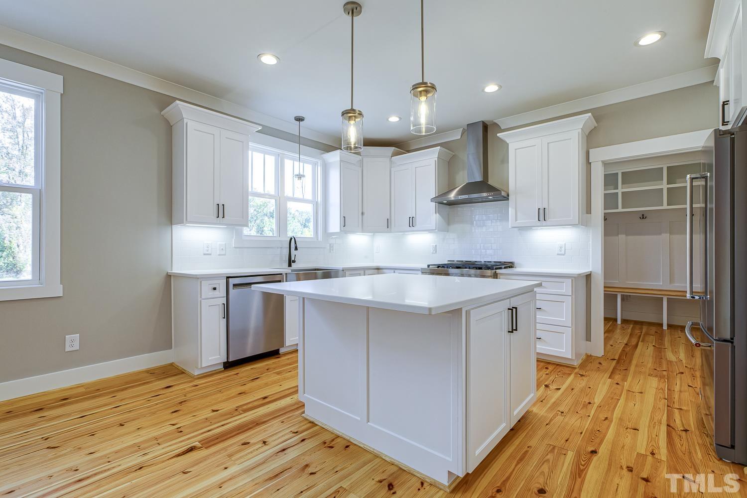 742 River Road Fuquay-Varina, NC 27526 - Photo 20 of 68 a kitchen with stainless steel appliances granite countertop a sink a stove and a refrigerator