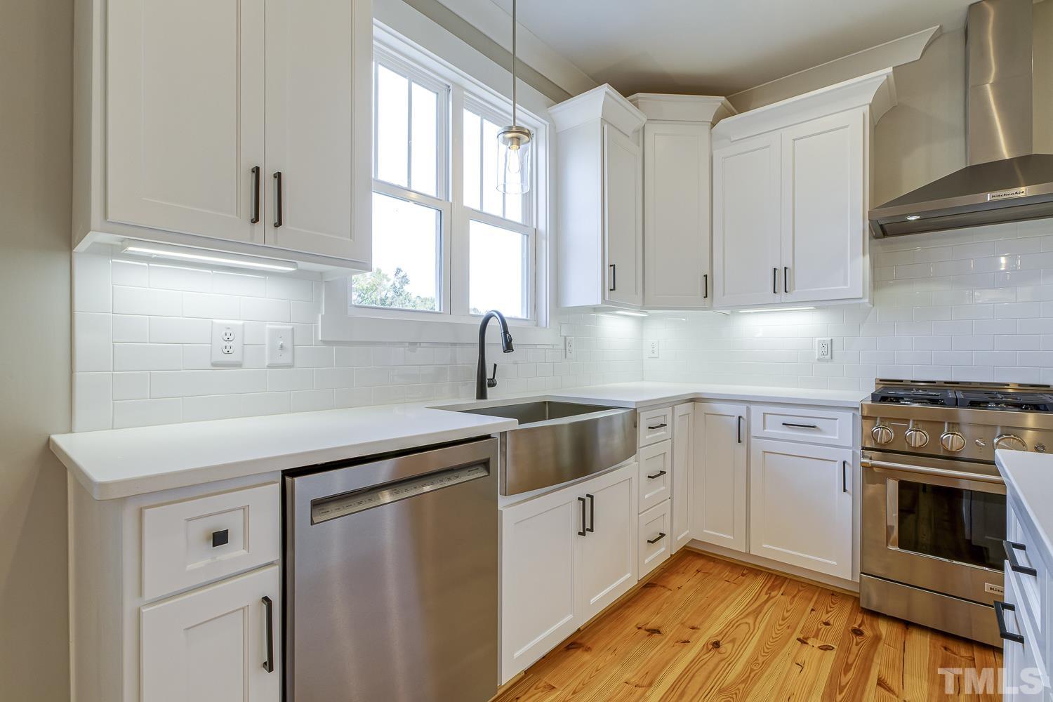 742 River Road Fuquay-Varina, NC 27526 - Photo 23 of 68 a kitchen with cabinets appliances a sink and a window