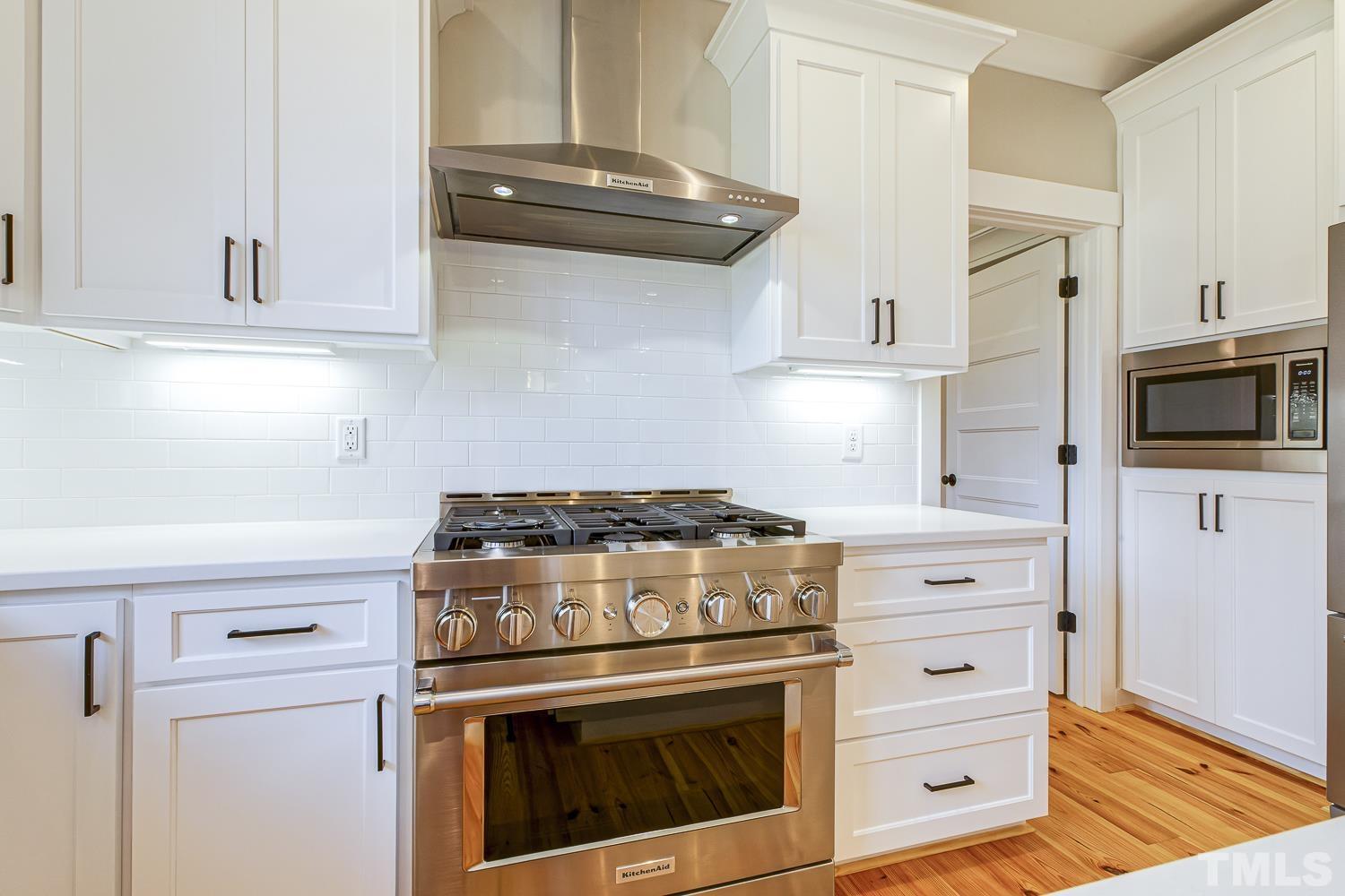 742 River Road Fuquay-Varina, NC 27526 - Photo 24 of 68 a stove top oven sitting inside of a kitchen
