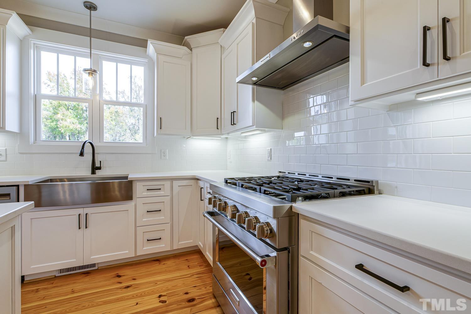 742 River Road Fuquay-Varina, NC 27526 - Photo 27 of 68 a kitchen with granite countertop a stove and a sink