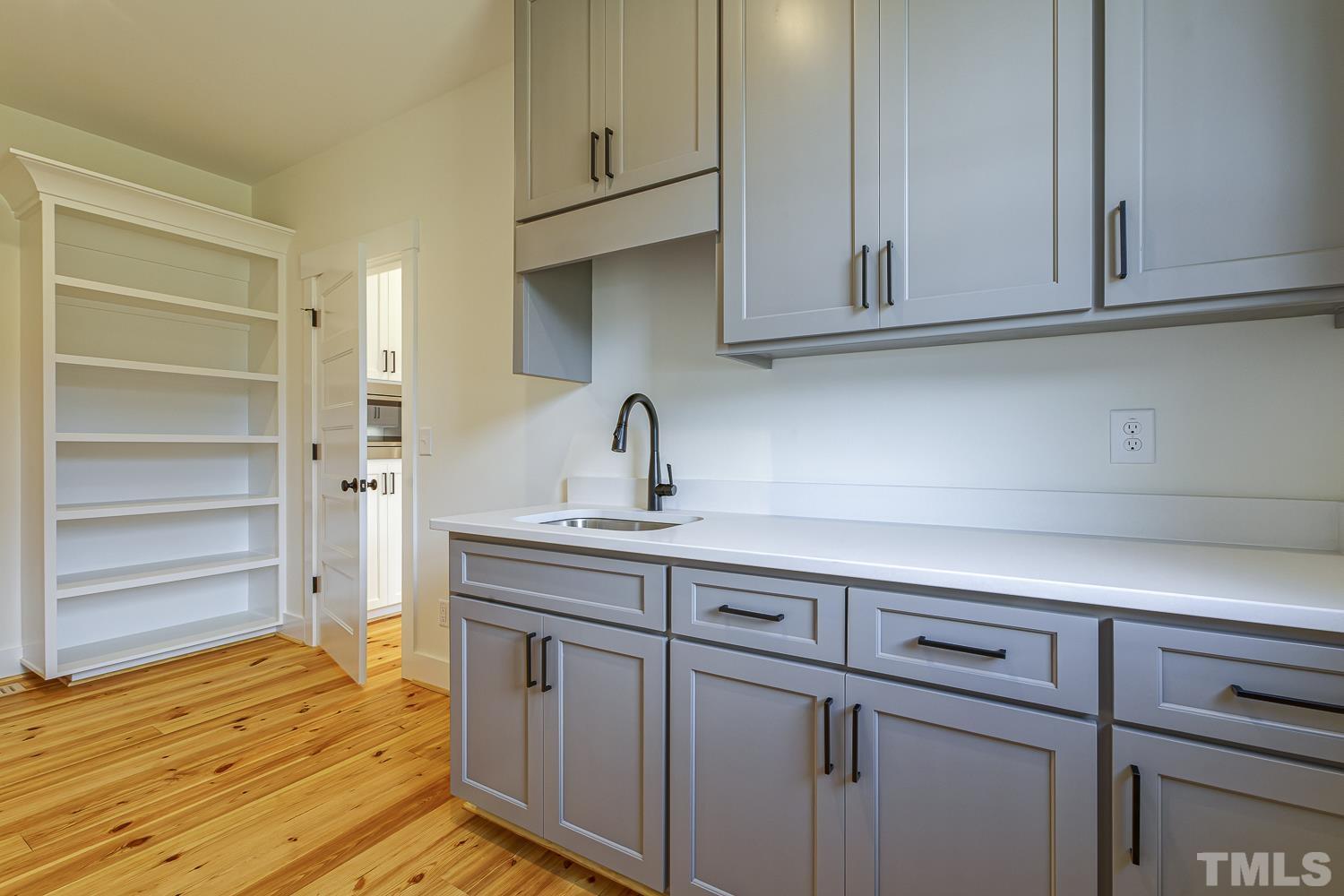 742 River Road Fuquay-Varina, NC 27526 - Photo 30 of 68 a kitchen with white cabinets and sink