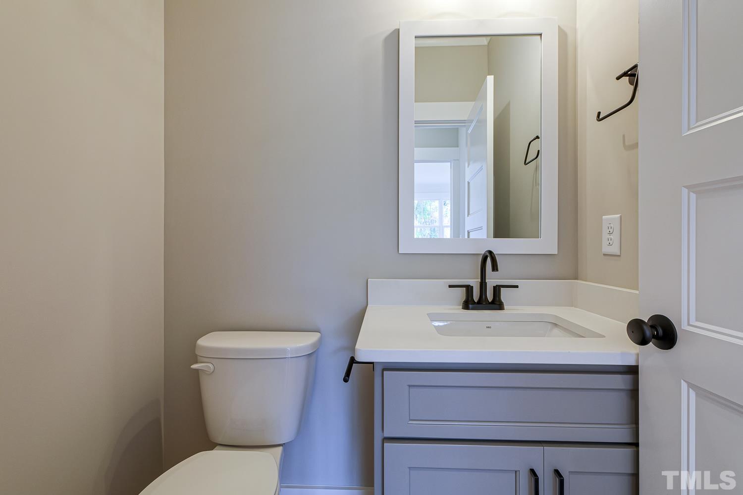 742 River Road Fuquay-Varina, NC 27526 - Photo 32 of 68 a bathroom with a sink toilet and mirror