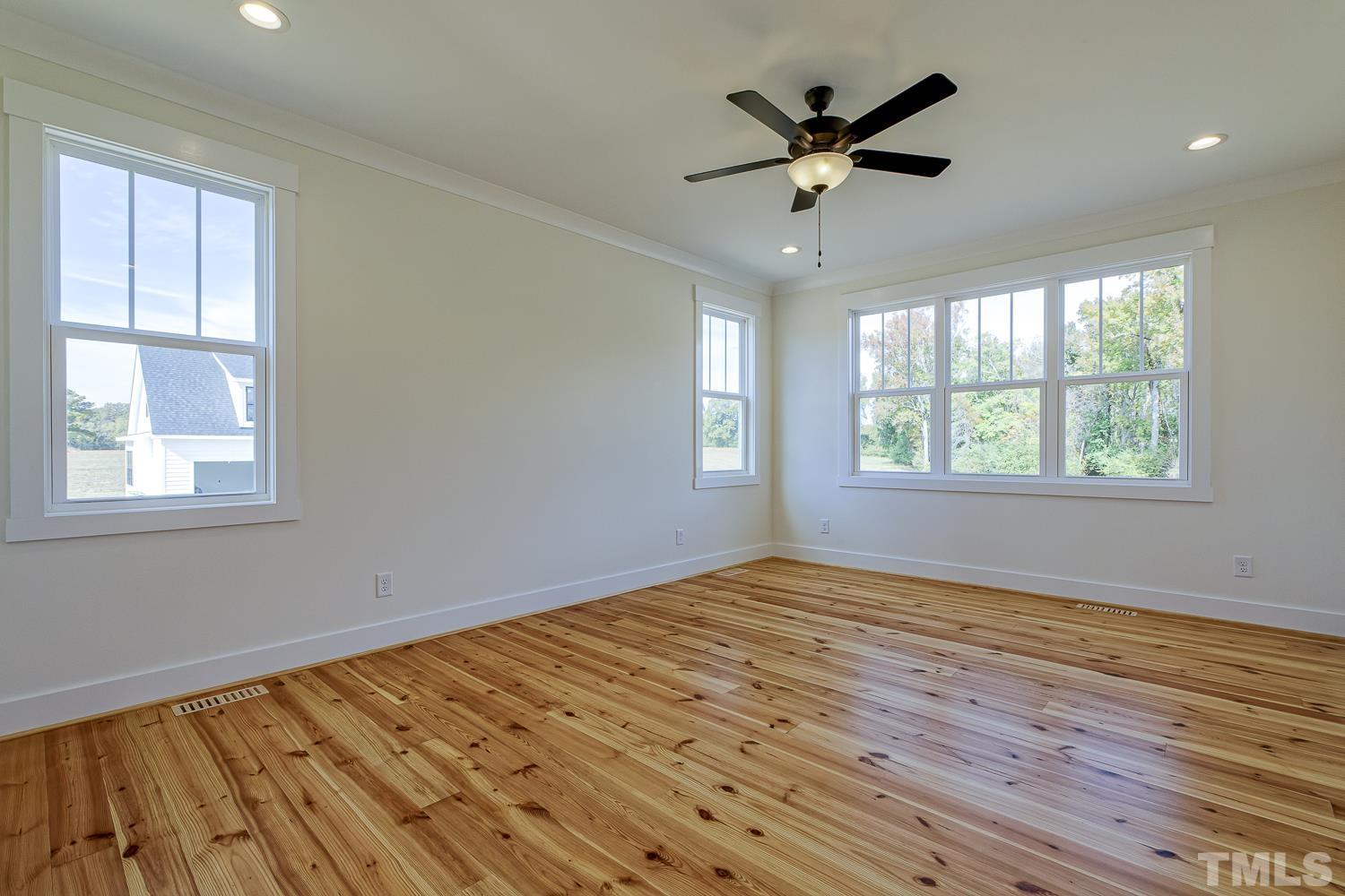 742 River Road Fuquay-Varina, NC 27526 - Photo 33 of 68 a view of an empty room with wooden floor and a window