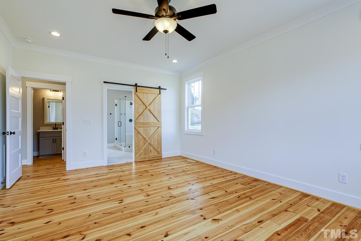 742 River Road Fuquay-Varina, NC 27526 - Photo 35 of 68 a view of empty room with wooden floor and fan