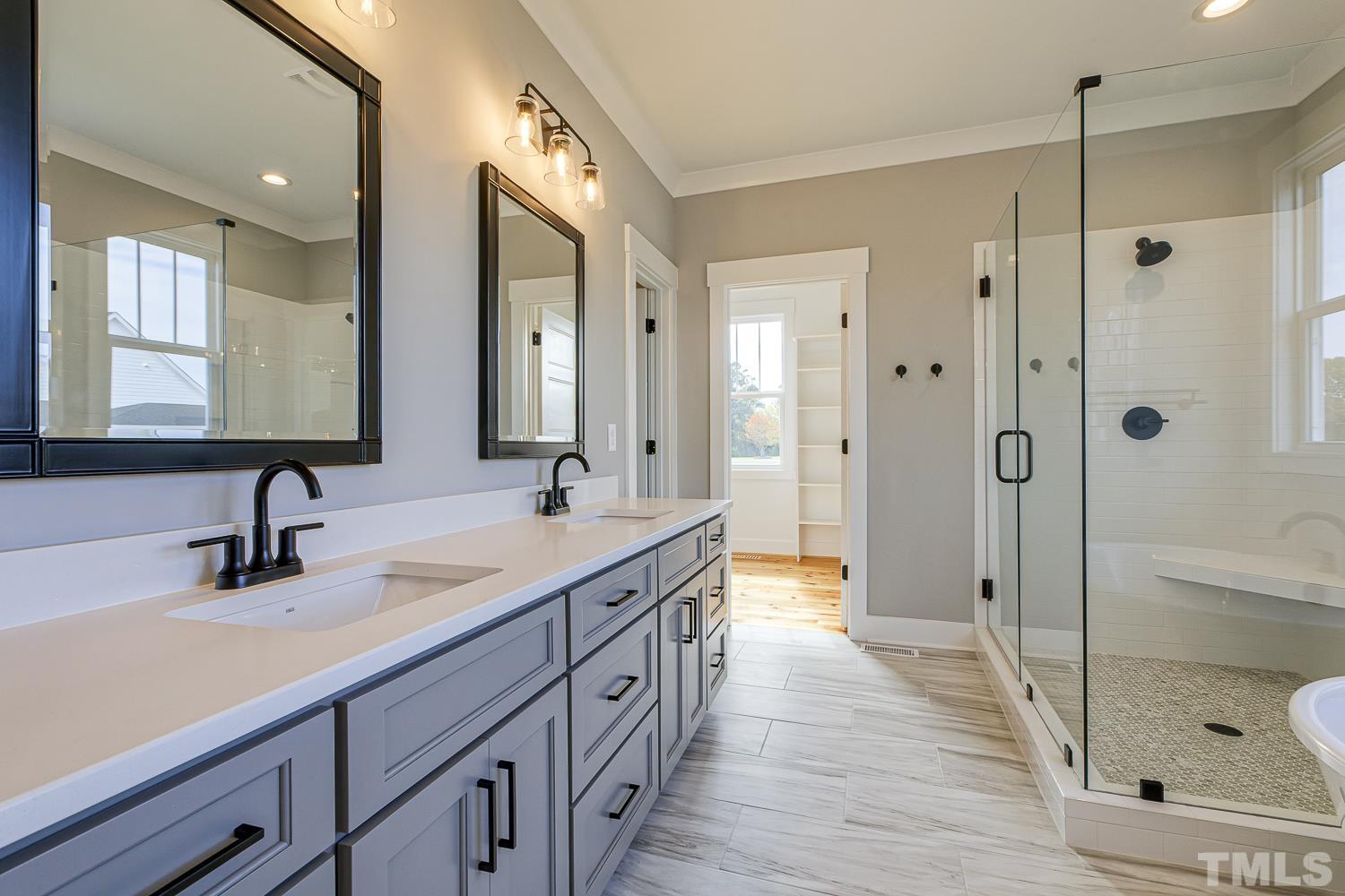 742 River Road Fuquay-Varina, NC 27526 - Photo 36 of 68 a spacious bathroom with a shower sink double mirror and shower