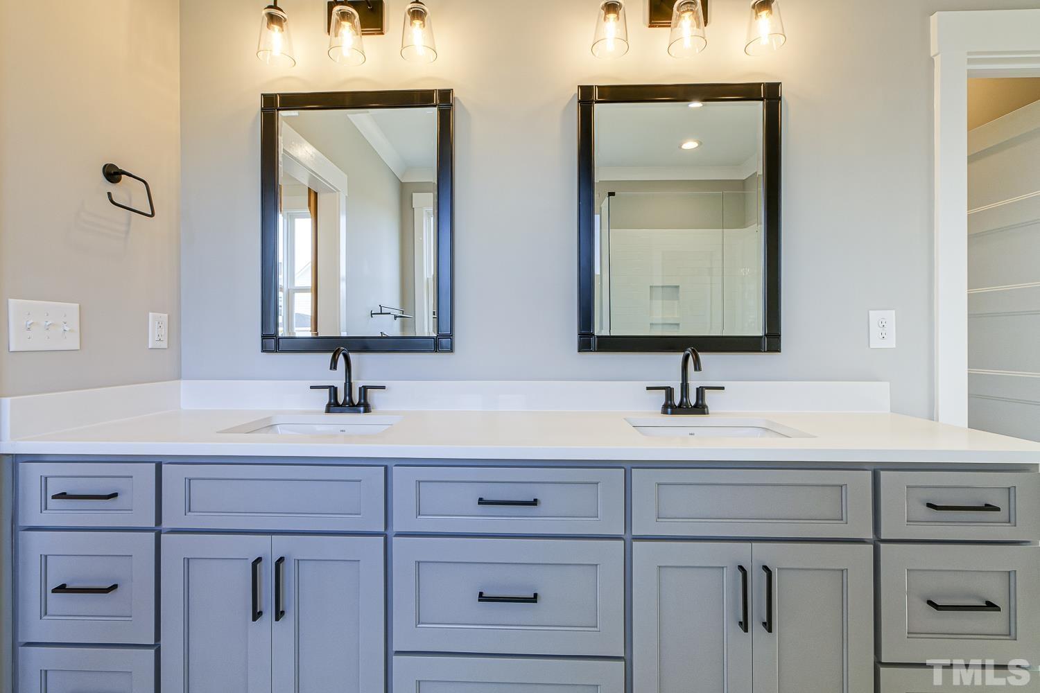 742 River Road Fuquay-Varina, NC 27526 - Photo 38 of 68 a bathroom with double vanity sinks and a mirror