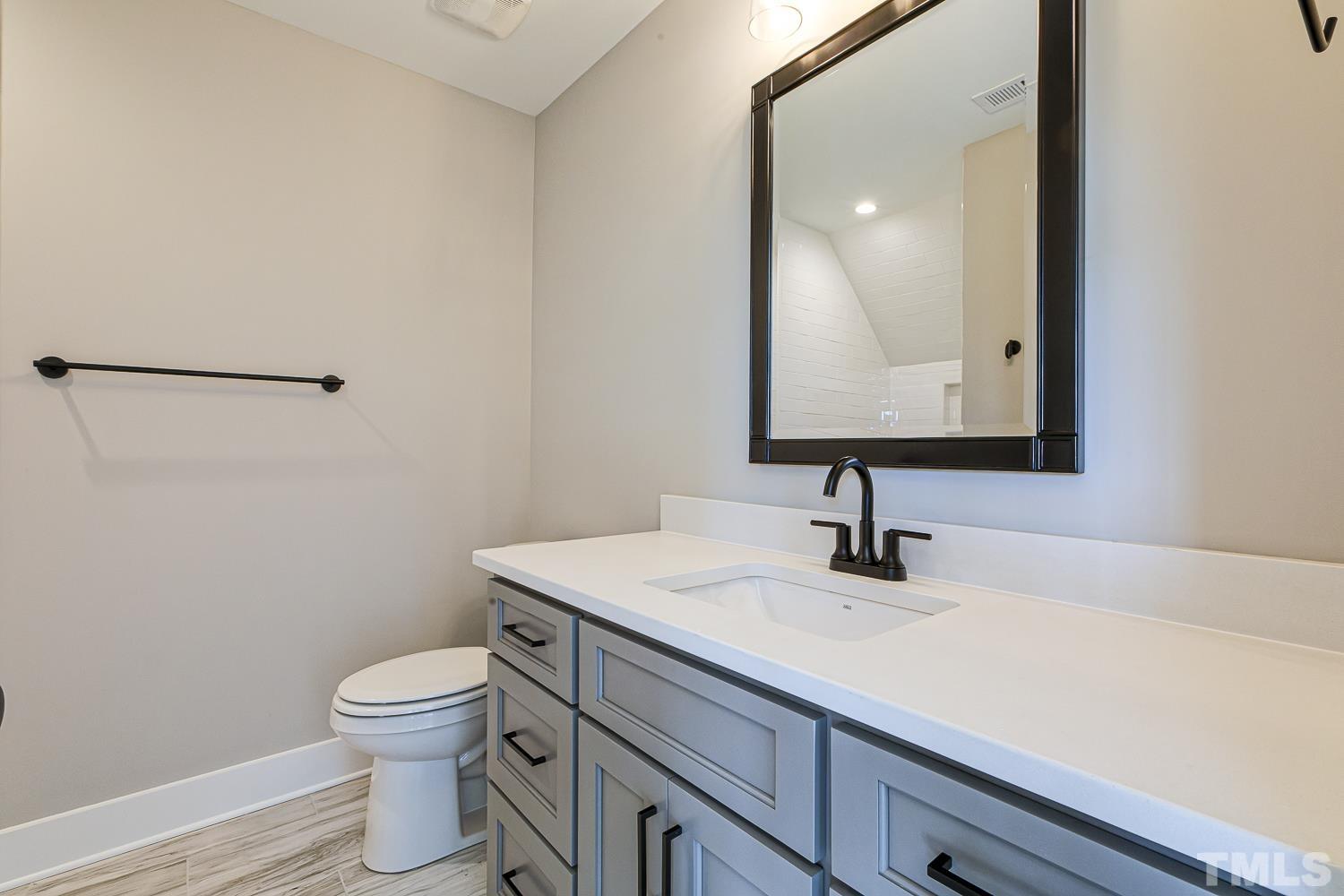 742 River Road Fuquay-Varina, NC 27526 - Photo 48 of 68 a bathroom with a sink toilet and mirror