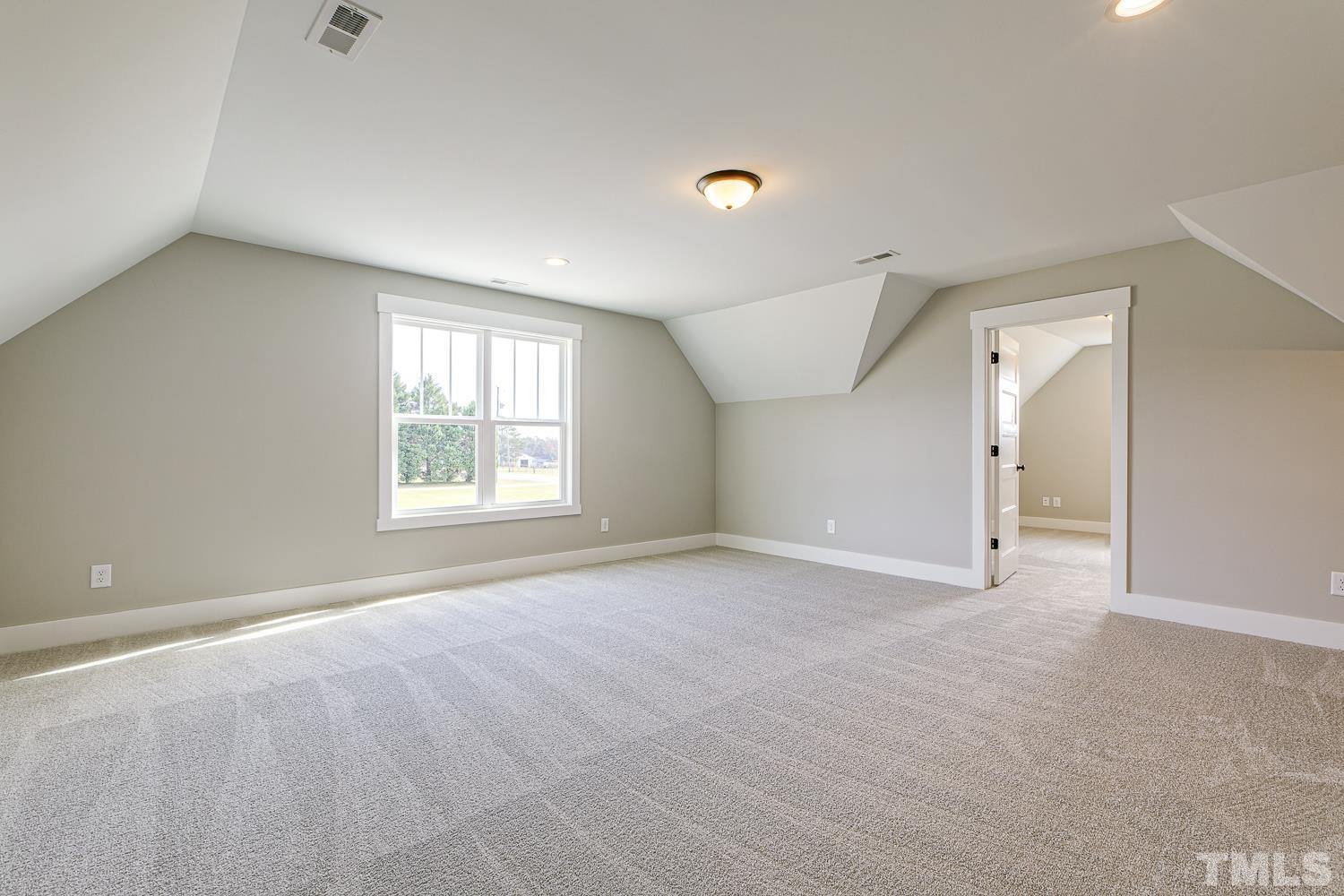 742 River Road Fuquay-Varina, NC 27526 - Photo 57 of 68 a view of an empty room with a window and a kitchen