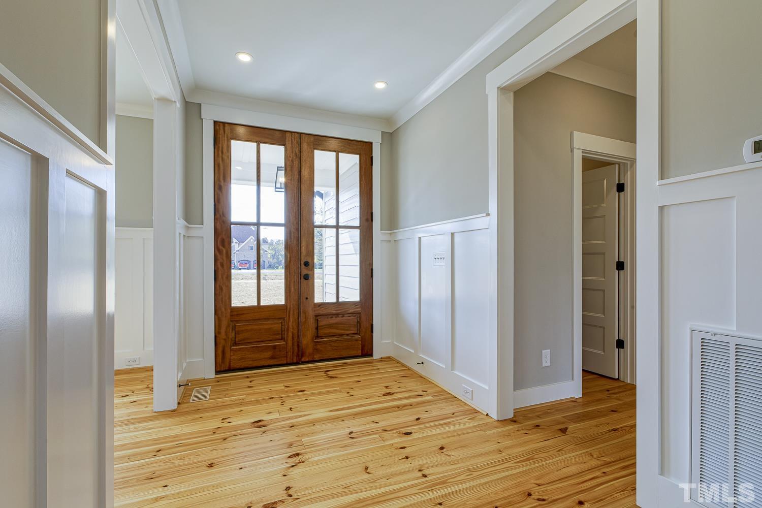 742 River Road Fuquay-Varina, NC 27526 - Photo 6 of 68 a view of an empty room with wooden floor and a window