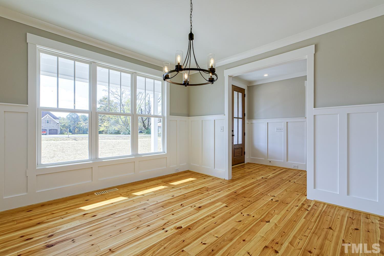 742 River Road Fuquay-Varina, NC 27526 - Photo 10 of 68 a view of a room with wooden floor staircase and a kitchen space
