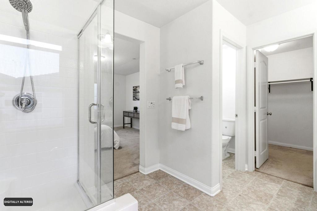 1508 Carpinteria Street Chula Vista, CA 91913 - Photo 17 of 39 a bathroom with a glass shower door a sink and a mirror