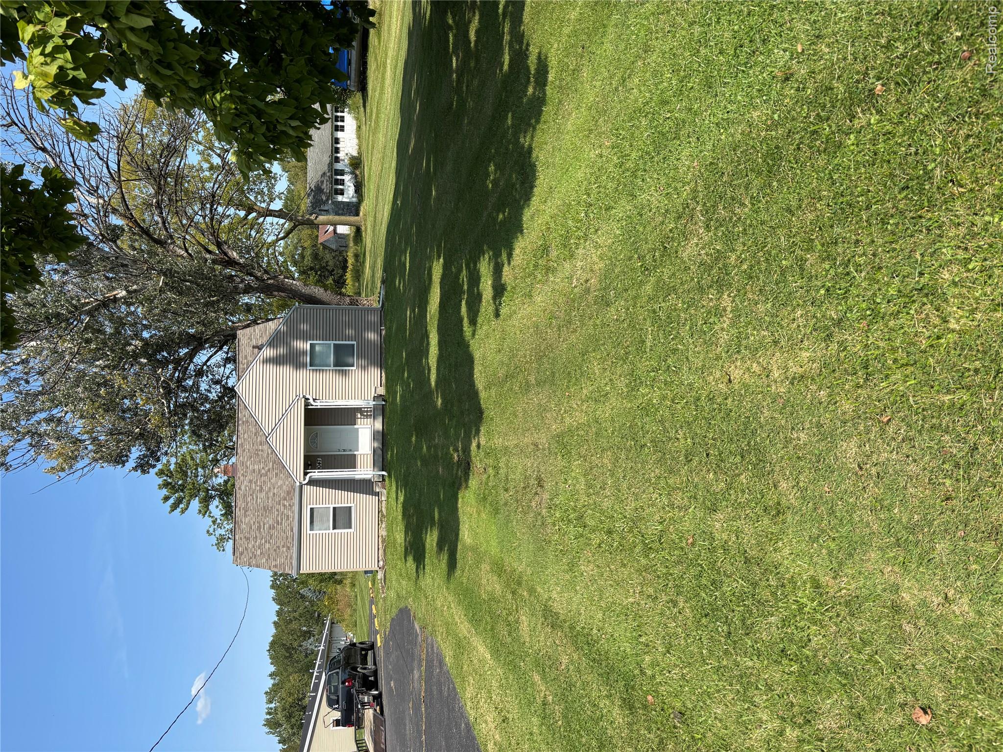 9047 Davison Road Davison, MI 48423 - Photo 11 of 11 Single-story residence featuring light-colored siding and a gabled roofline