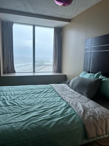 a bedroom with a bed and a window