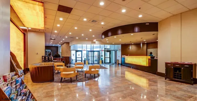 a lobby with furniture and floor to ceiling window