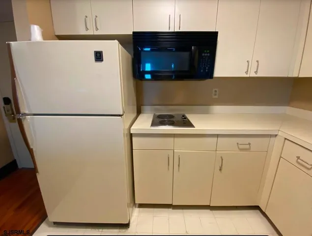 a white refrigerator freezer sitting inside of a kitchen