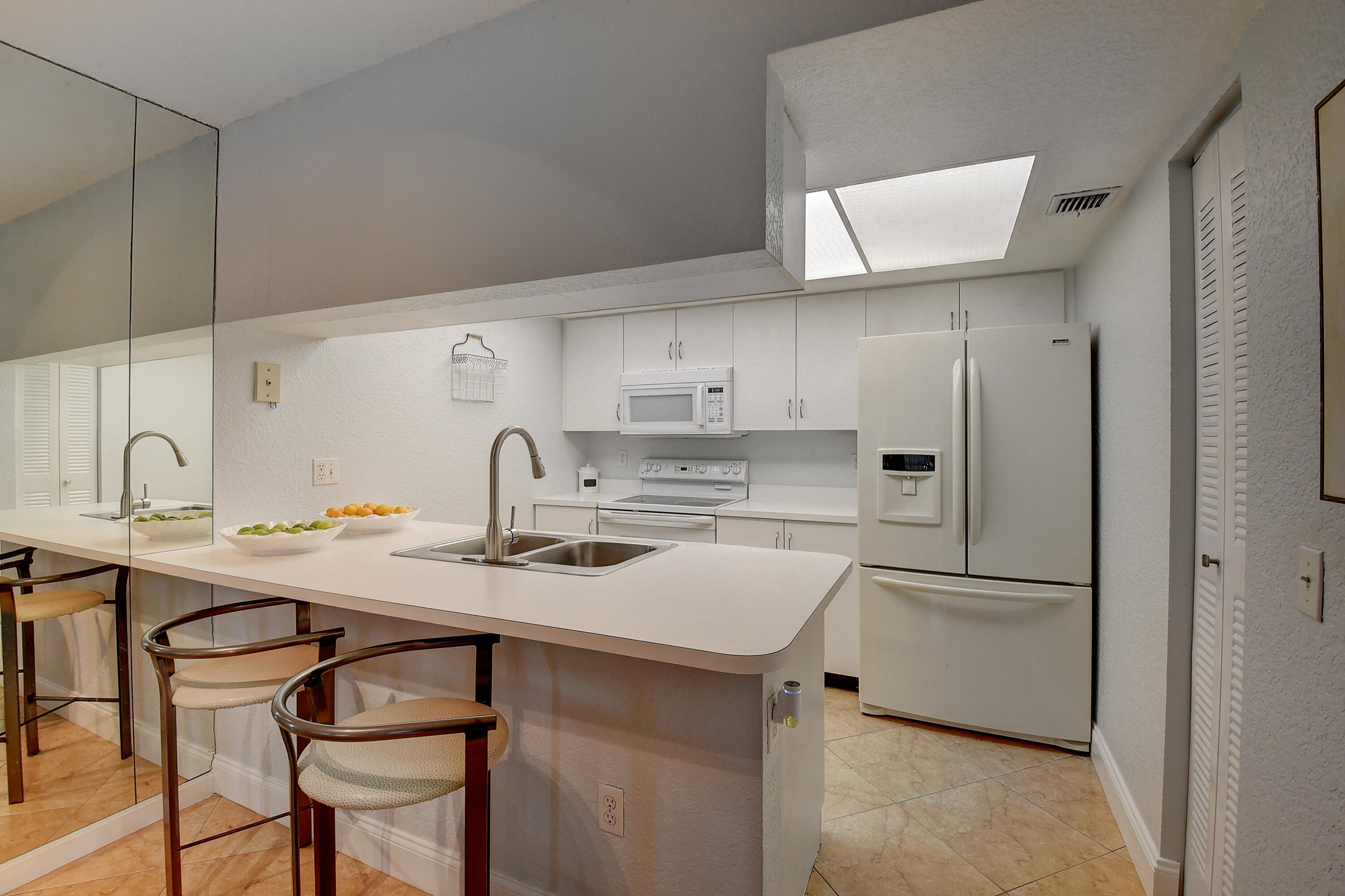 604 Waterside Drive, Unit 604 Hypoluxo, FL 33462 - Photo 9 of 21 Kitchen with eat-in Bar area