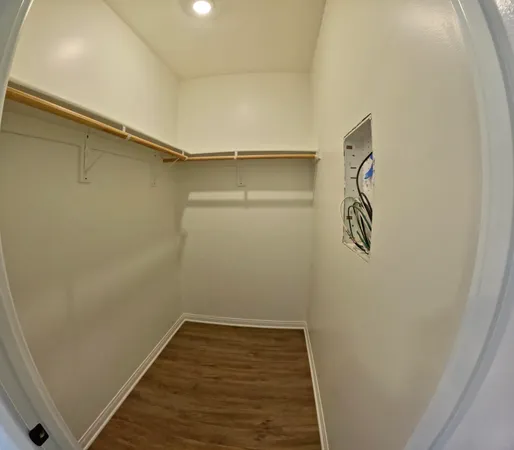 a view of a room with wooden floor