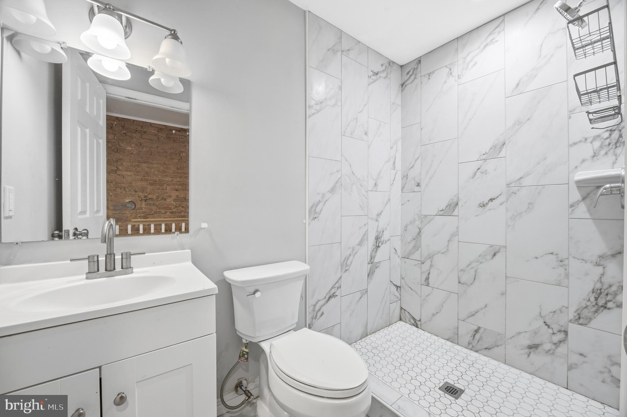 714 North Duncan Street Baltimore, MD 21205 - Photo 24 of 24 a bathroom with a toilet a sink and a shower