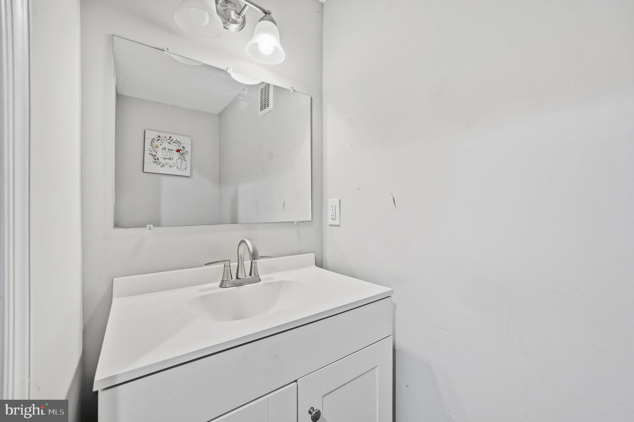 714 North Duncan Street Baltimore, MD 21205 - Photo 9 of 24 a bathroom with a sink and a mirror