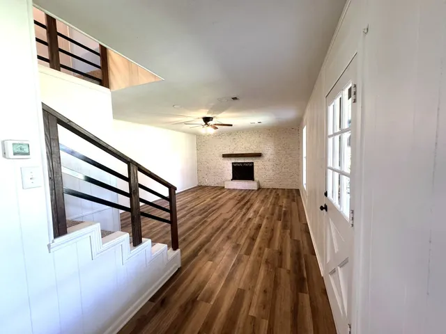 a view of entryway and hall with wooden floor