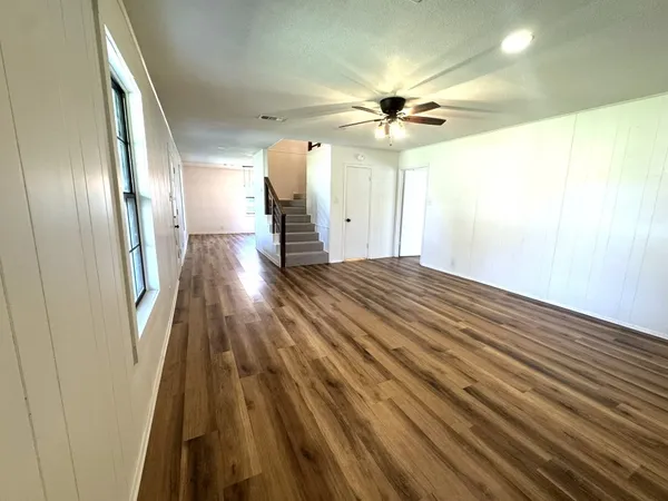 a kitchen with stainless steel appliances a refrigerator sink and wooden floor
