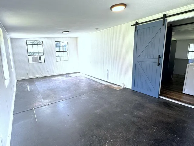 a spacious bedroom with a bed and a flat screen tv