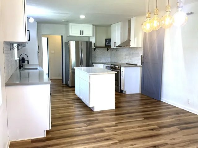 a view of empty room with floor to ceiling windows