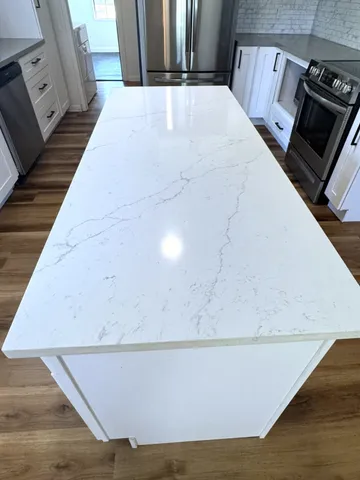 a spacious bedroom with a bed a mirror and a window