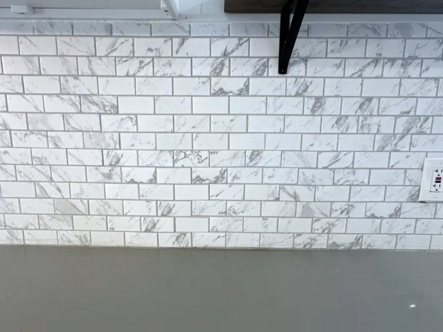 a spacious bedroom with a bed and a window