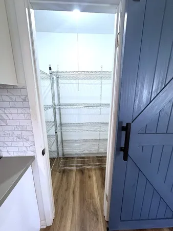 a spacious bedroom with a bed a mirror and a window