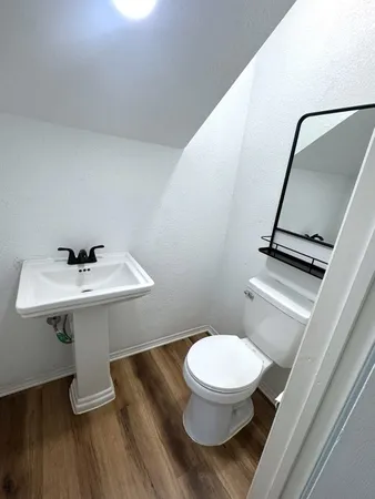 a bathroom with a double vanity sink and mirror with window