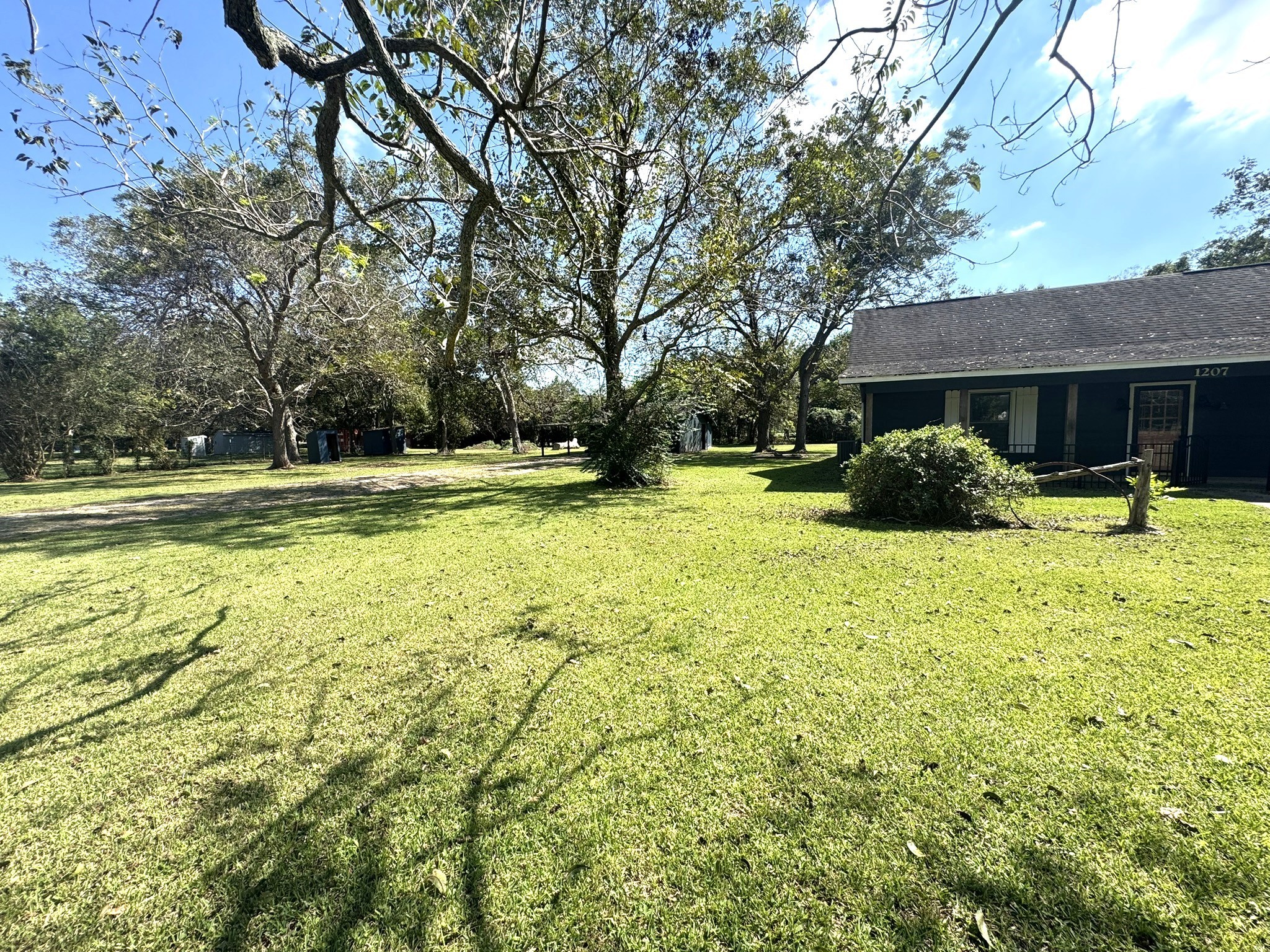 1207 Half Moon Drive Wharton, TX 77488 - Photo 4 of 50 a backyard of a house with yard and outdoor seating