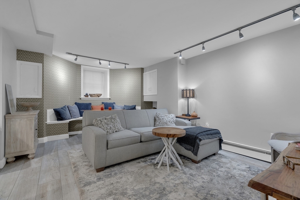 14 Auburn Street, Unit A Boston, MA 02129 - Photo 2 of 10 a living room with furniture and a fireplace