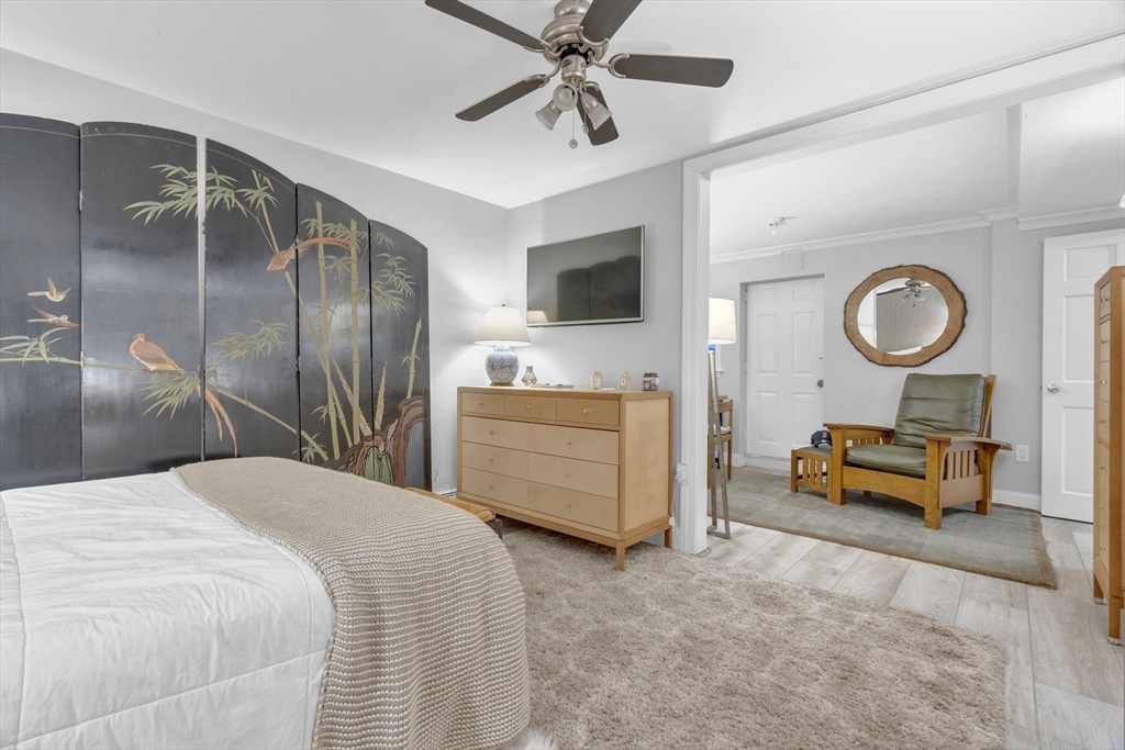 14 Auburn Street, Unit A Boston, MA 02129 - Photo 8 of 10 a bedroom with a bed and a chandelier