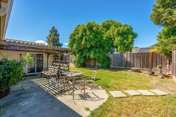 a view of a chair and tables in the backyard