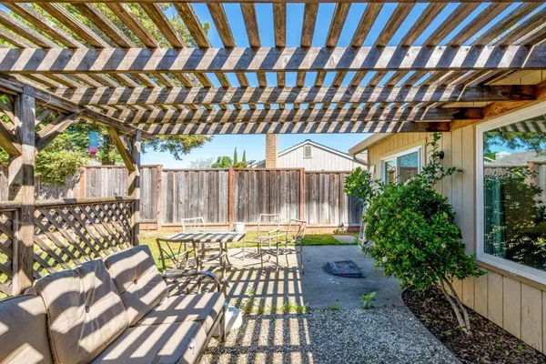 a view of a chair and tables in the patio