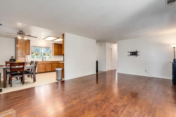 a view of a living room a dining room and wooden floor