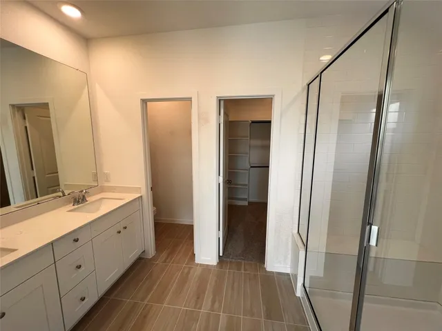 a bathroom with a double vanity sink and a mirror
