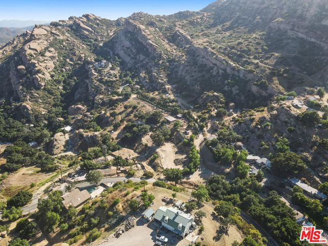 a view of a backyard with sitting area