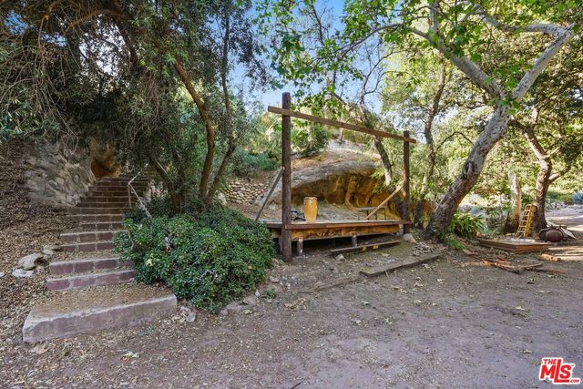 a view of a house with truck parked on a road