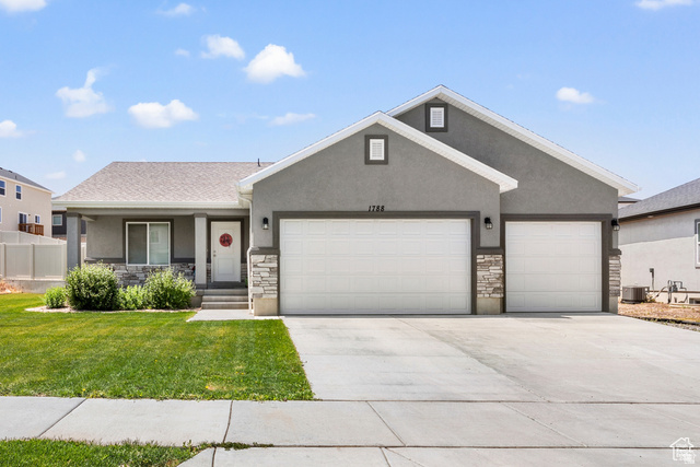 1788 South Longview Road Santaquin, UT 84655 - Photo 1 of 1 View of front of house featuring an attached garage, stone siding, driveway, and stucco siding