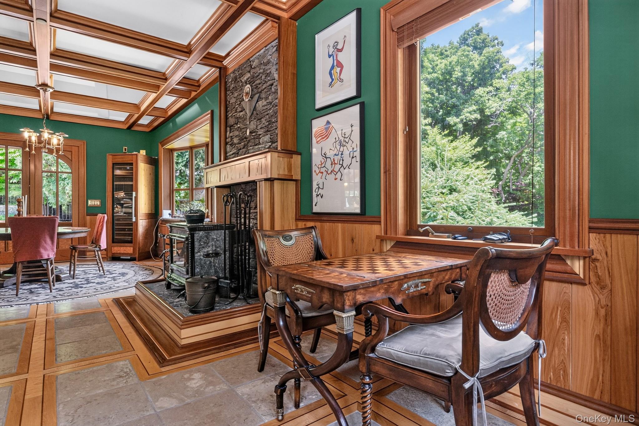 23 Inningwood Road Ossining, NY 10562 - Photo 21 of 50 Interior room featuring a wood-paneled coffered ceiling and a prominent wood-burning stove on a raised hearth