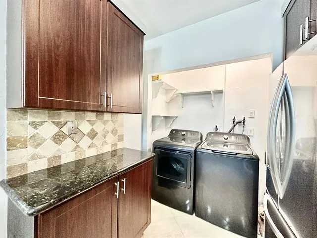 a kitchen with granite countertop a sink stove and cabinets