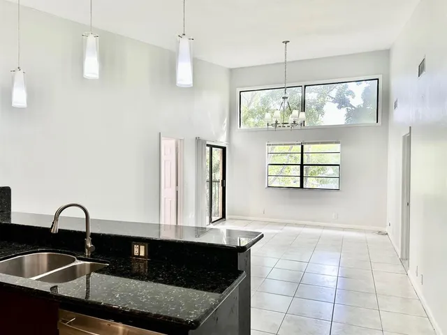 a kitchen with a sink a counter top space and stainless steel appliances